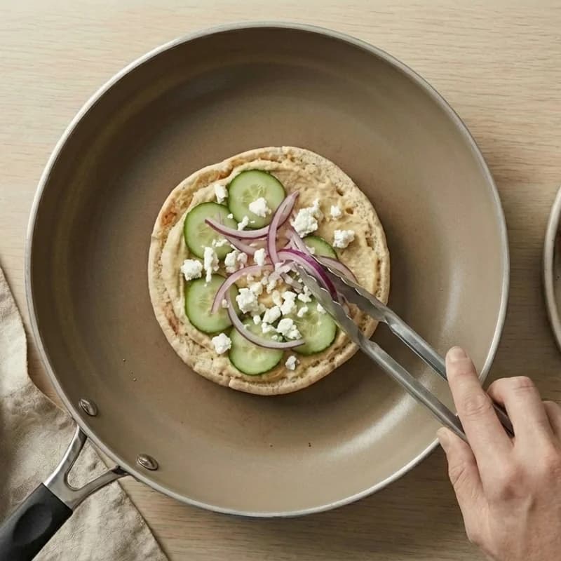 Step 4: Add sliced red onion and crumbled feta cheese.