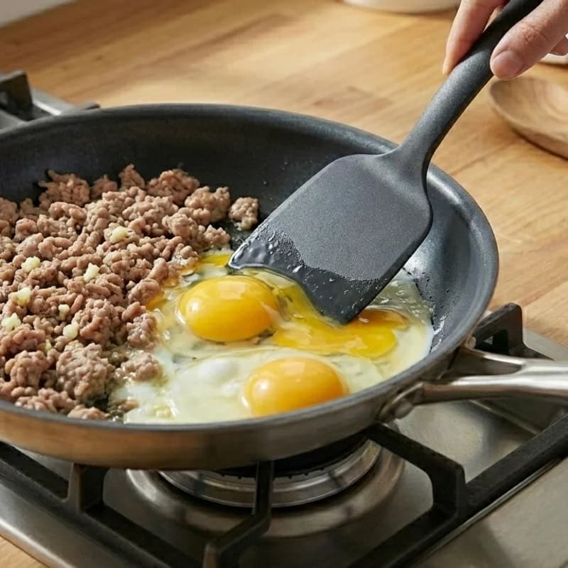 Step 3: Push turkey to one side of the pan. Crack eggs into the empt